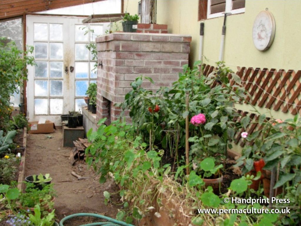 Turning a Wood Stove into a Mass Heater to Warm a Greenhouse Permaculture